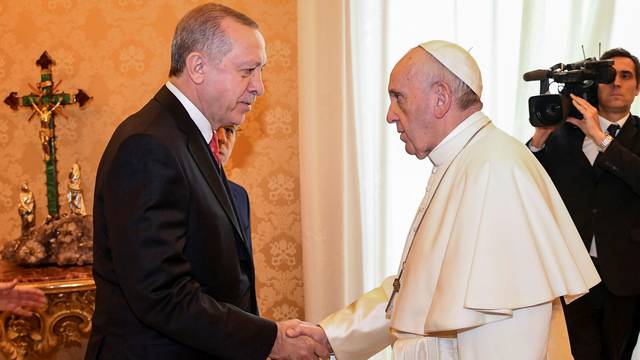 Pope Francis welcomes Turkish President Tayyip Erdogan during a private audience at the Vatican