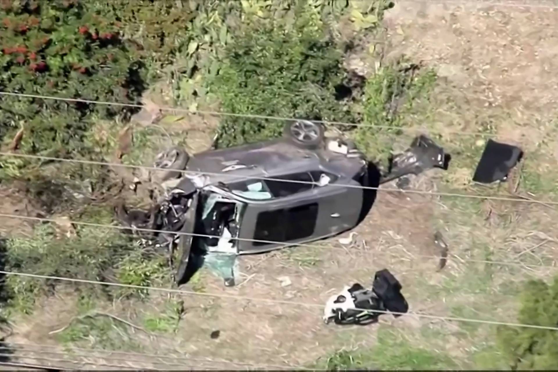 The vehicle of golfer Tiger Woods lies on its side after being involved in a single-vehicle accident in Los Angeles