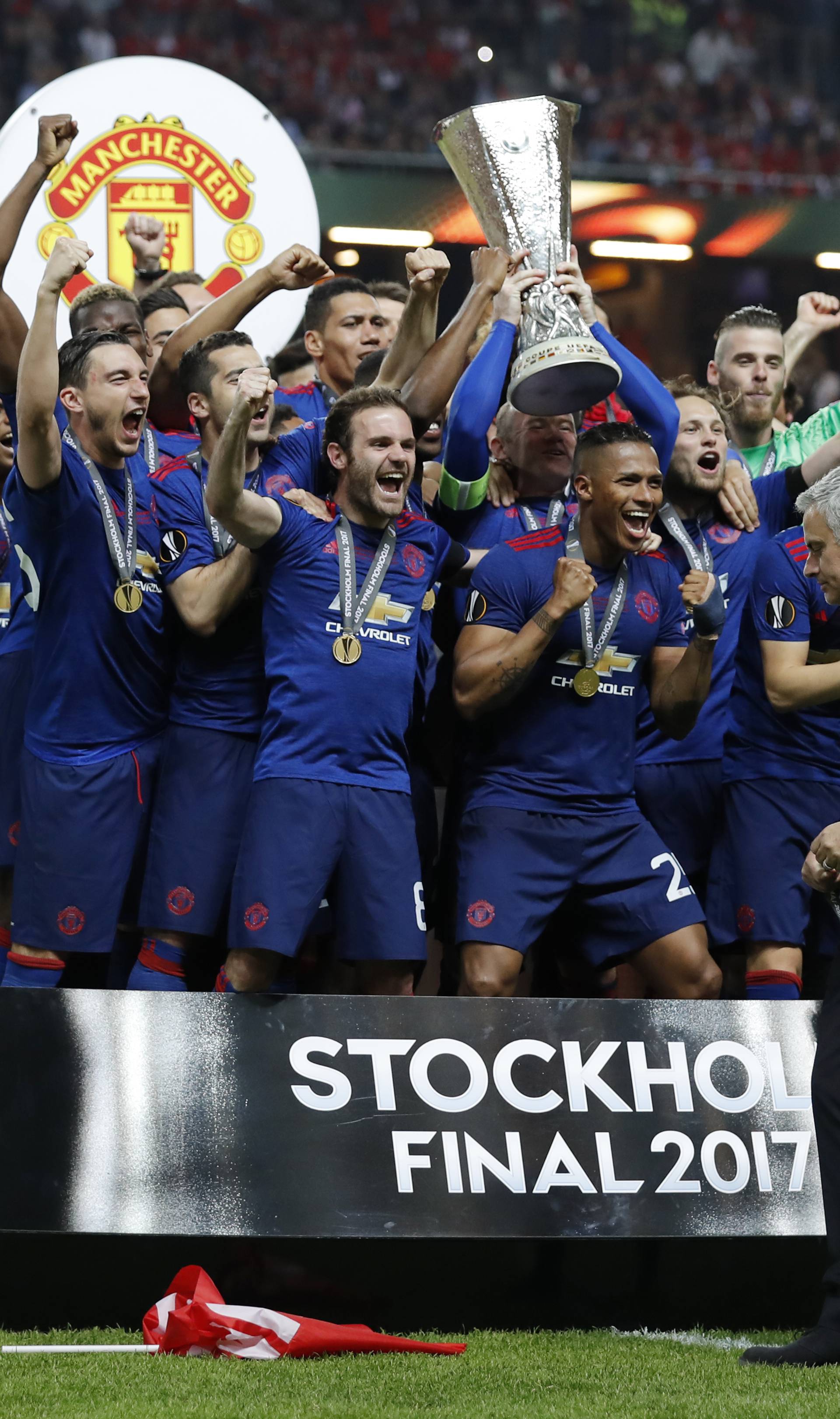 Manchester United celebrate winning the Europa League with the trophy