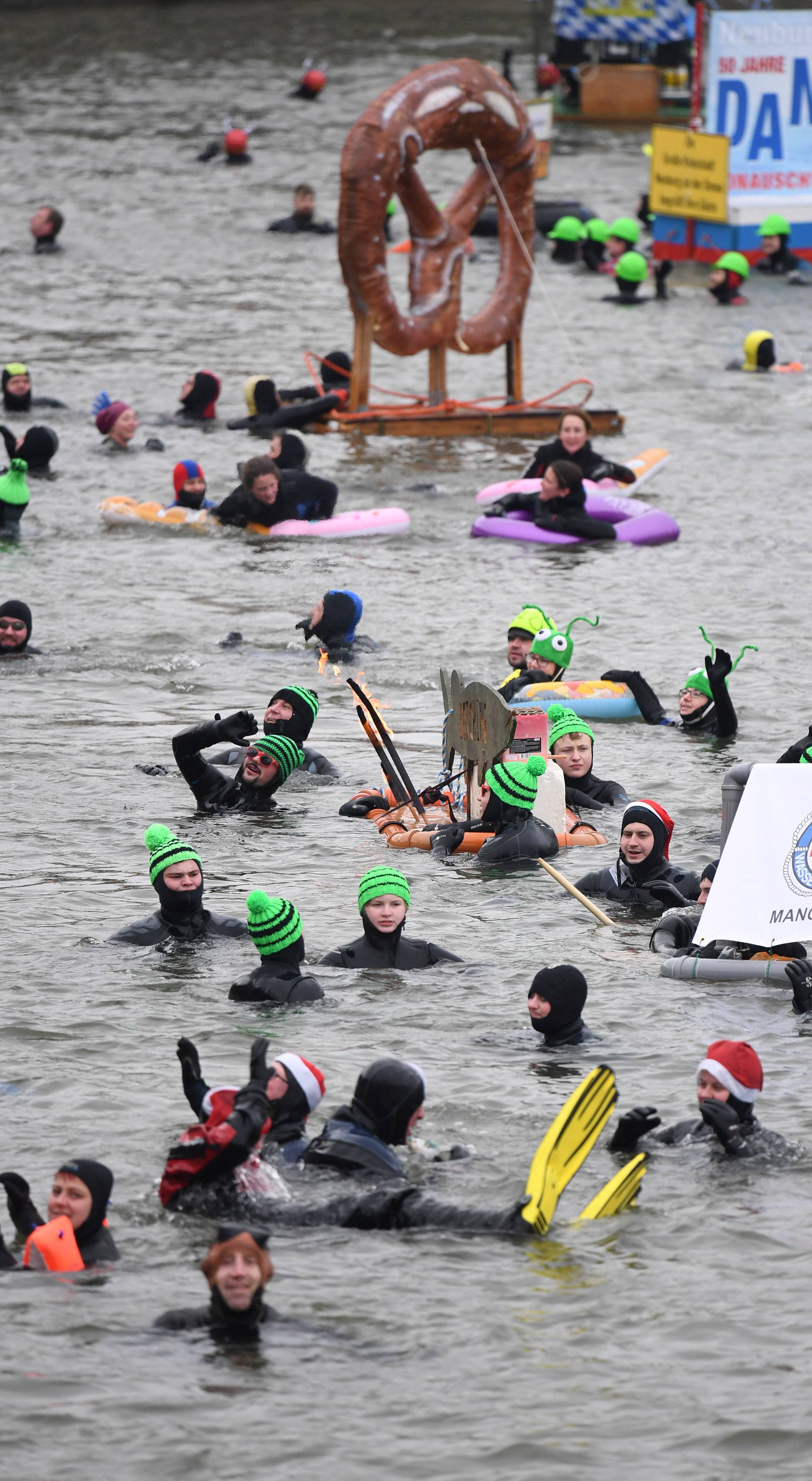 Swimmers wearing costumes bathe in the 3 degrees Celsius water of the river Danube in Neuburg an der Donau