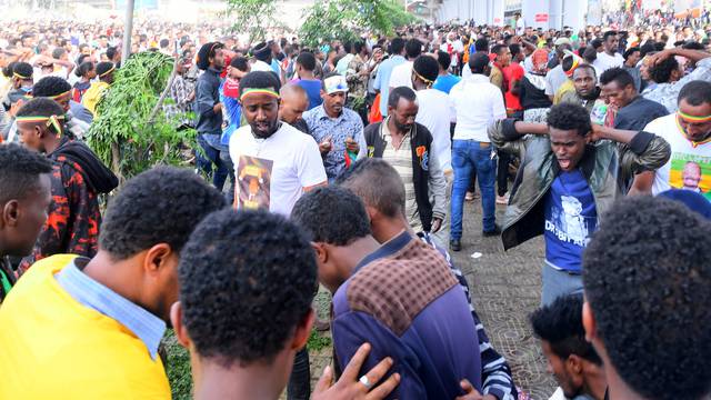 Ethiopians react after an explosion during a rally in support of the new Prime Minister Abiy Ahmed in Addis Ababa