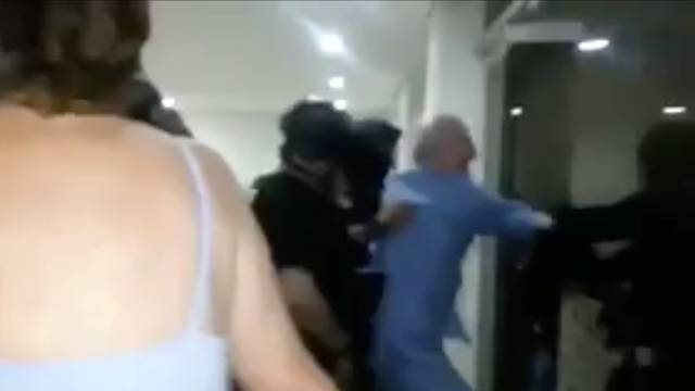 A still image taken from a social media video said to show the moment in which former Caracas Mayor Antonio Ledezma is led under arrest from his home, in Caracas