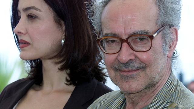 FILE PHOTO: Swiss director Jean Luc Godard (R) smiles as he stands with actress Cecile Camp (L) for their film "..