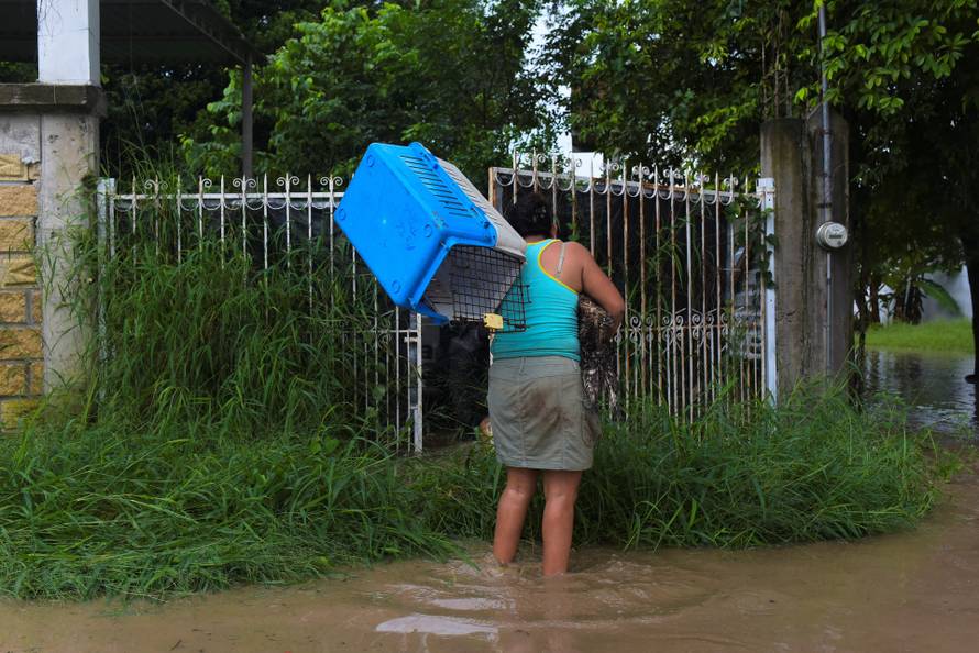 Torrential rains burst rivers, sparking floods in eastern Mexico