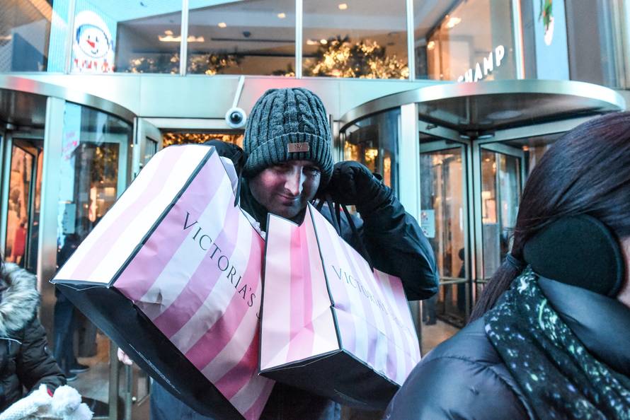 A man exits the Macy's flagship store during a Black Friday sales event in New York City