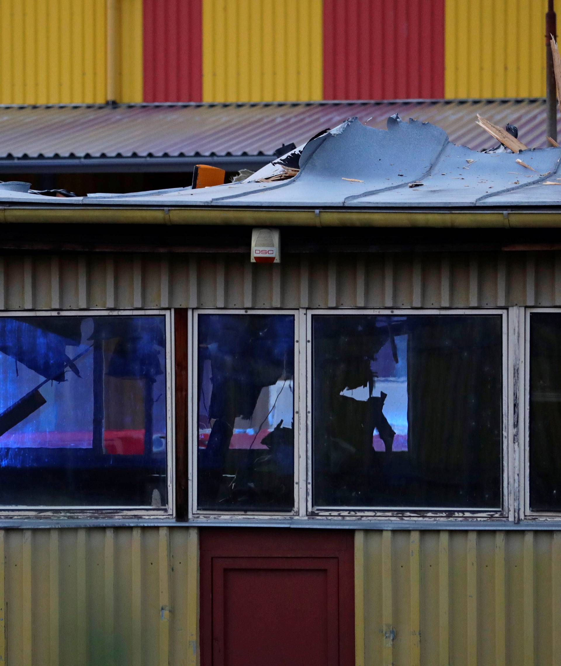 The wreckage of a small helicopter that crashed into an industrial hall is seen on the crash site in Plzen