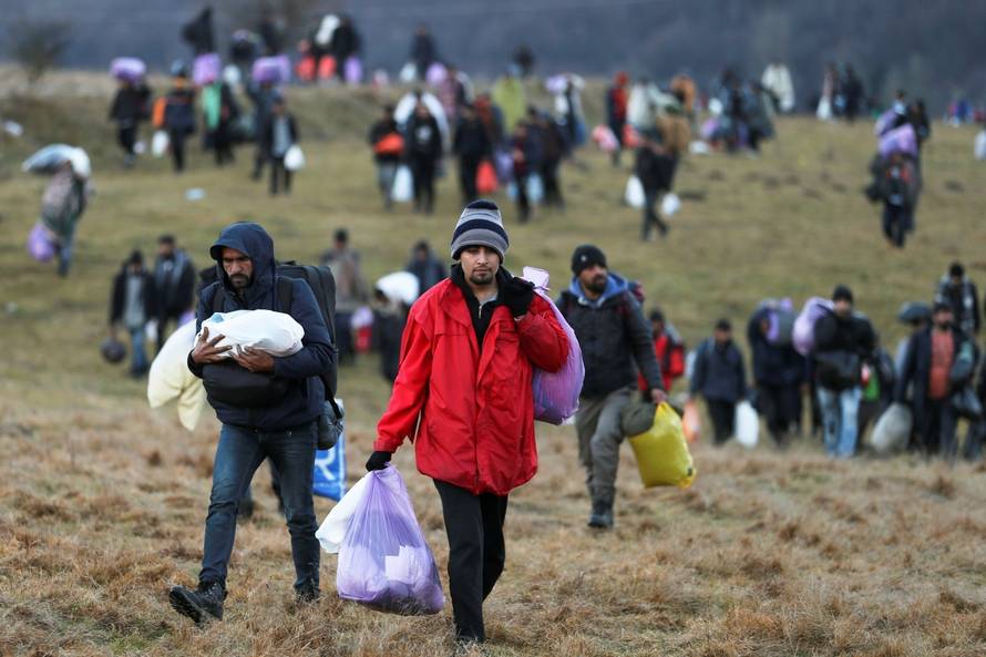 Migrants walk towards the forest after camp "Lipa" was closed, in Bihac