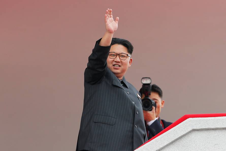 North Korean leader Kim Jong Un waves to the crowd as he presides over a mass rally and parade in Pyongyang