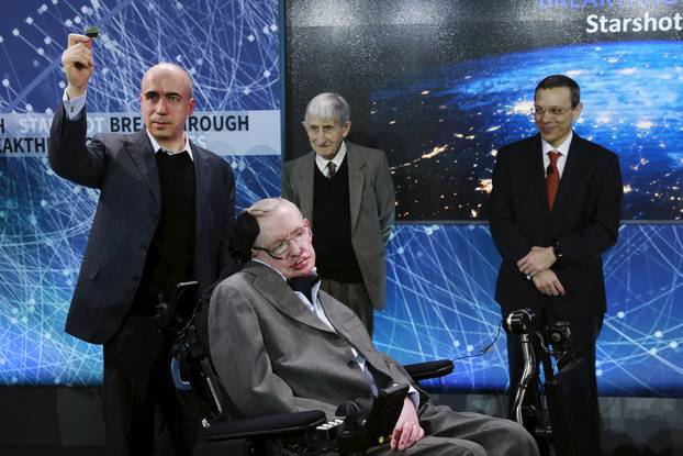 Physicist Stephen Hawking sits in front of  investor Yuri Milner (L), physicist Freeman Dyson (C), and physicist Avi Loeb on stage during an announcement of the Breakthrough Starshot initiative in New York