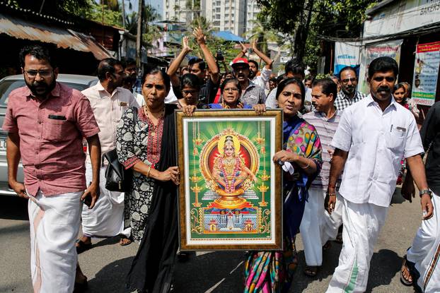 Protesters hold a portrait of Hindu deity âAyappaâ as they take part in a rally called by various Hindu organisations after two women entered the Sabarimala temple, in Kochi