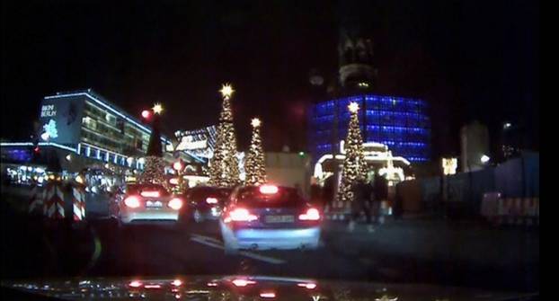 An image grab from a car dash camera shows people running away after a truck plowed into a Christmas market in Berlin