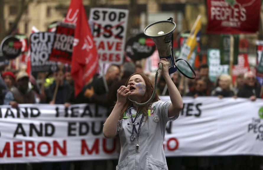 A demonstrator shouts through a megaphone during an anti-austerity protest in London