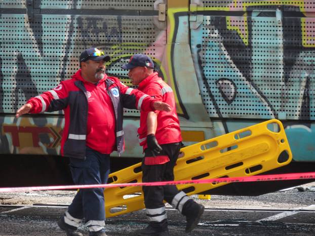 Authorities work at the scene where a passenger bus was struck by a train, in Atlacomulco