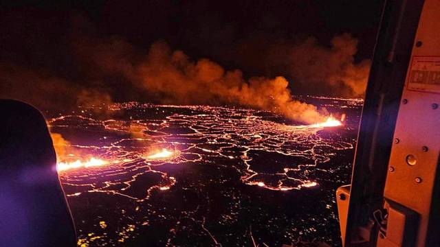 A volcano spews lava and smoke as it erupts near Grindavik