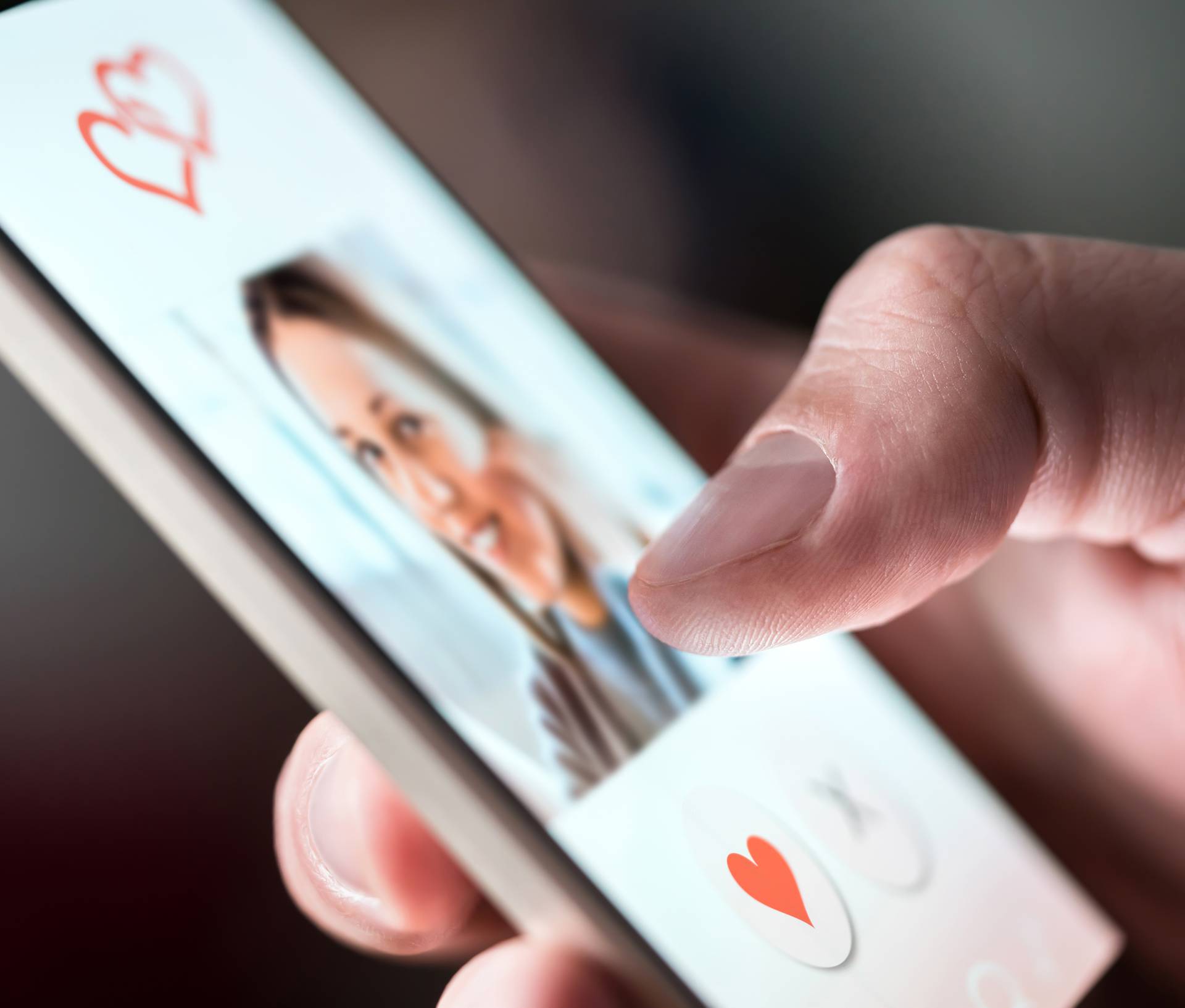 Online dating app in smartphone. Man looking at photo of beautif