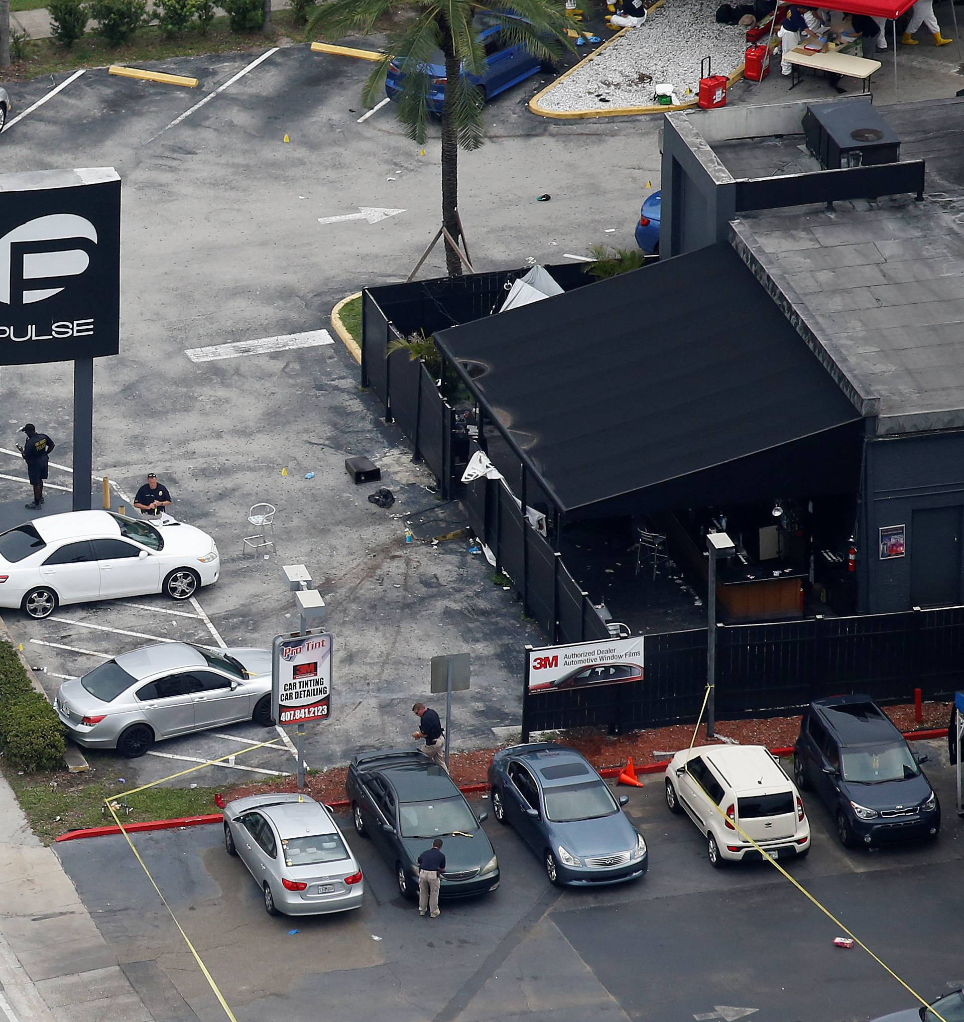 Investigators work the scene following a mass shooting at the Pulse gay nightclub in Orlando Florida