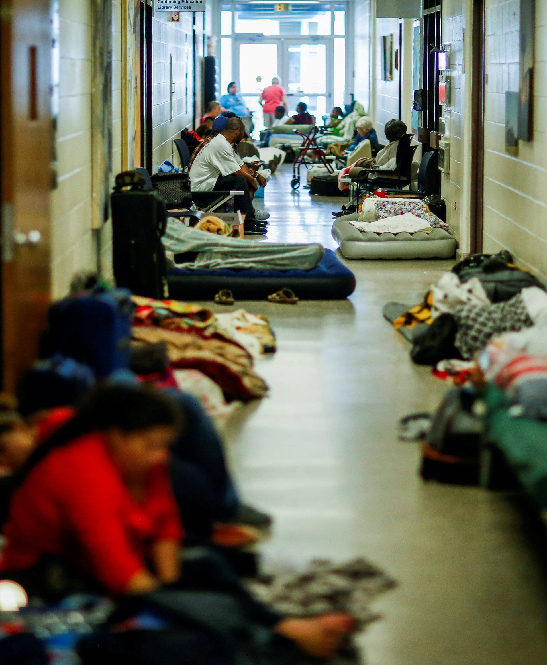 People are seen inside a shelter run by Red Cross before Hurricane Florence comes ashore in Grantsboro, North Carolina