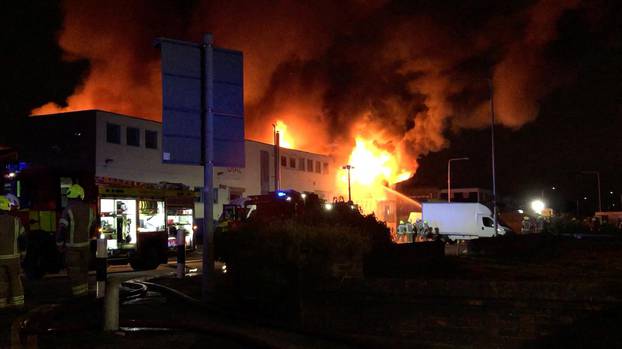 Emergency responders work at the scene of a fire at Hainault Business Park in London