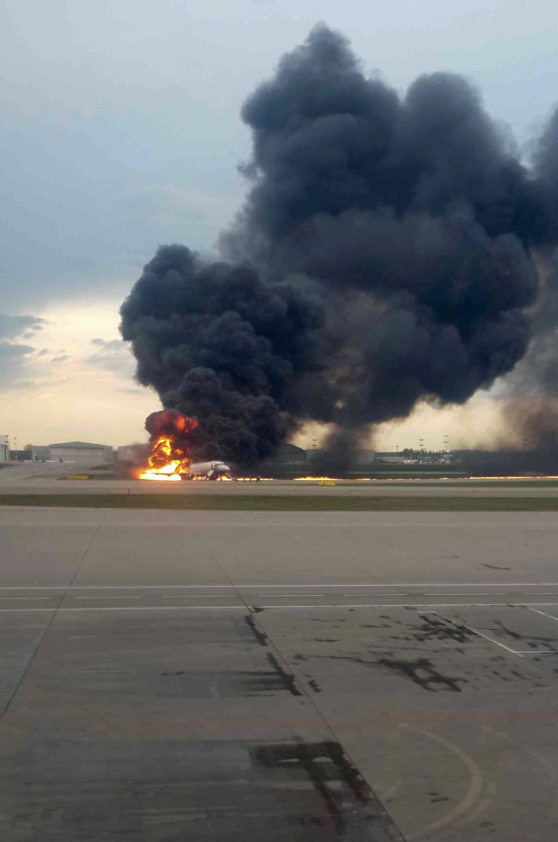 A passenger plane is seen on fire after an emergency landing at the Sheremetyevo Airport outside Moscow