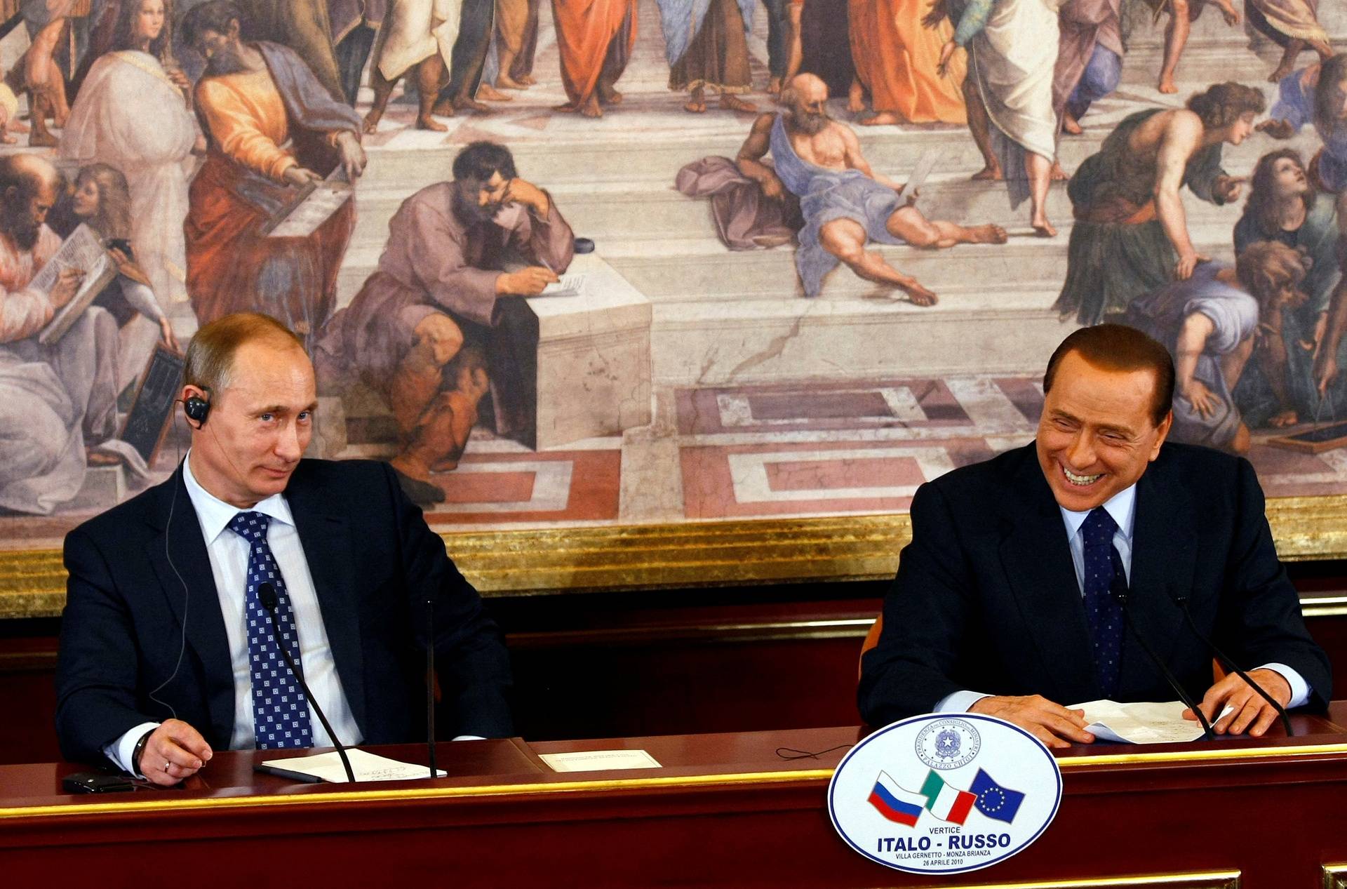 FILE PHOTO: Italian PM Berlusconi smiles as Russian PM Putin looks on during a news conference at a summit in Gerno