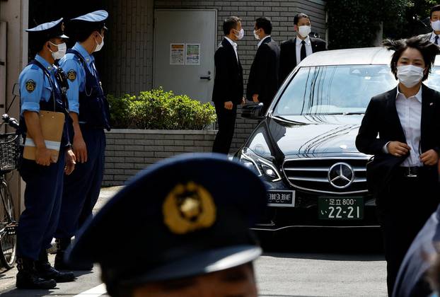 A vehicle believed to be carrying the body of former Japanese Prime Minister Shinzo Abe who was shot while campaigning for a parliamentary election, arrives at his residence in Tokyo