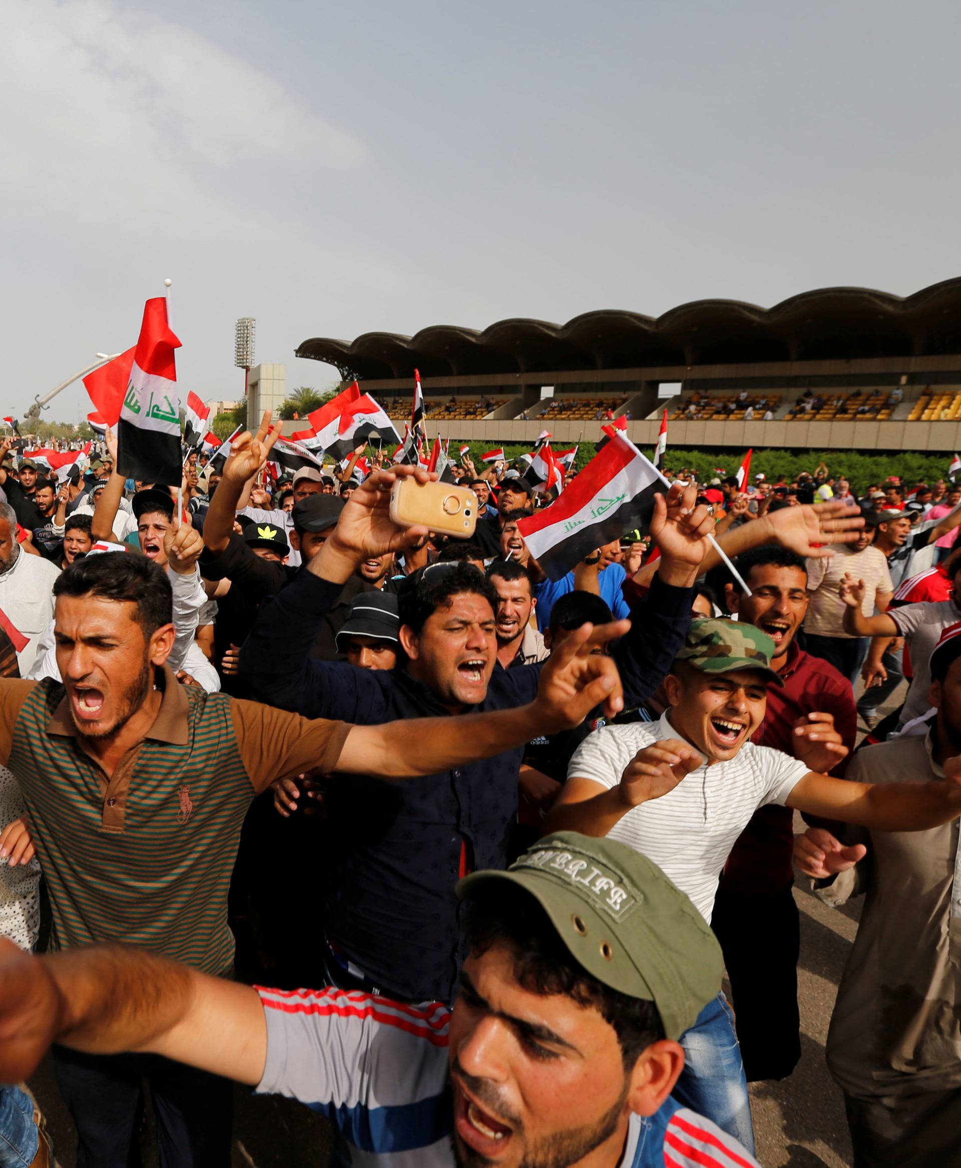 Followers of Iraq's Shi'ite cleric Moqtada al-Sadr shout slogans at Grand Festivities Square within the Green Zone in Baghdad