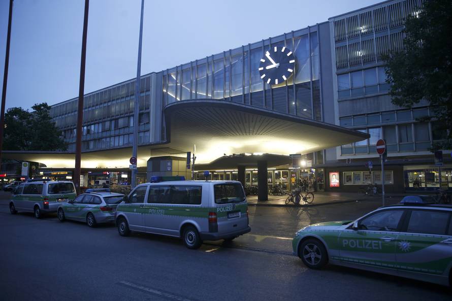 Police vehicles stand outside the main train station following shooting rampage at shopping mall in Munich