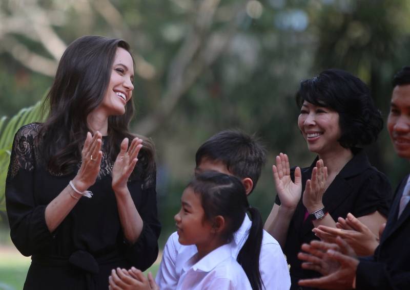 Actress Angelina Jolie and Cambodian-born American human rights activist and lecturer Loung Ung laugh as they arrive for a news conference at a hotel in Siem Reap province