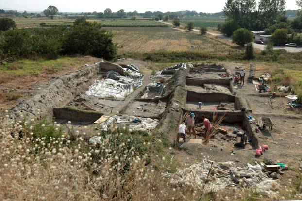 Bulgarian archaeologists dig during excavation works in an ancient settlement near the village of Yunatsite