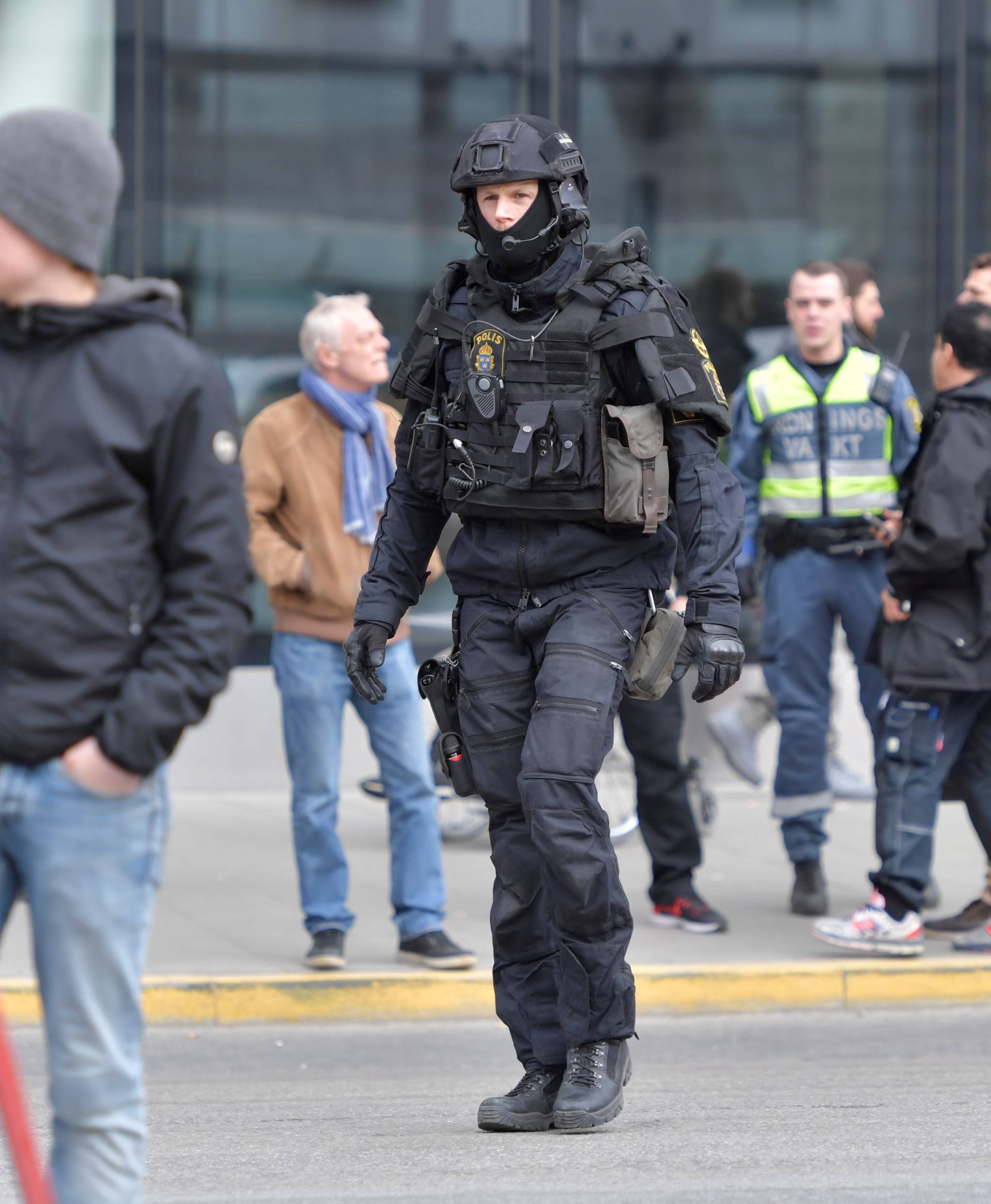 A policeman is seen evacuating Stockholm Central Train Station after people were killed when a truck crashed into department store Ahlens, in central Stockholm