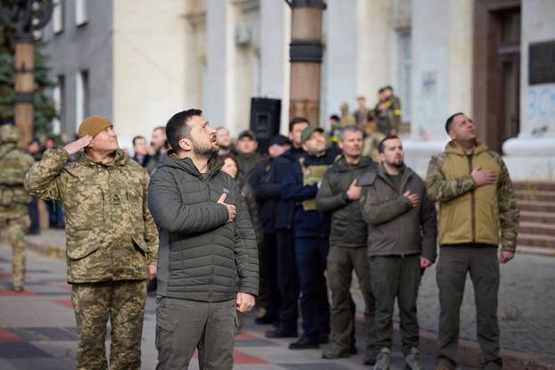Ukraine's President Volodymyr Zelenskiy sings the national anthem during his visit in Kherson