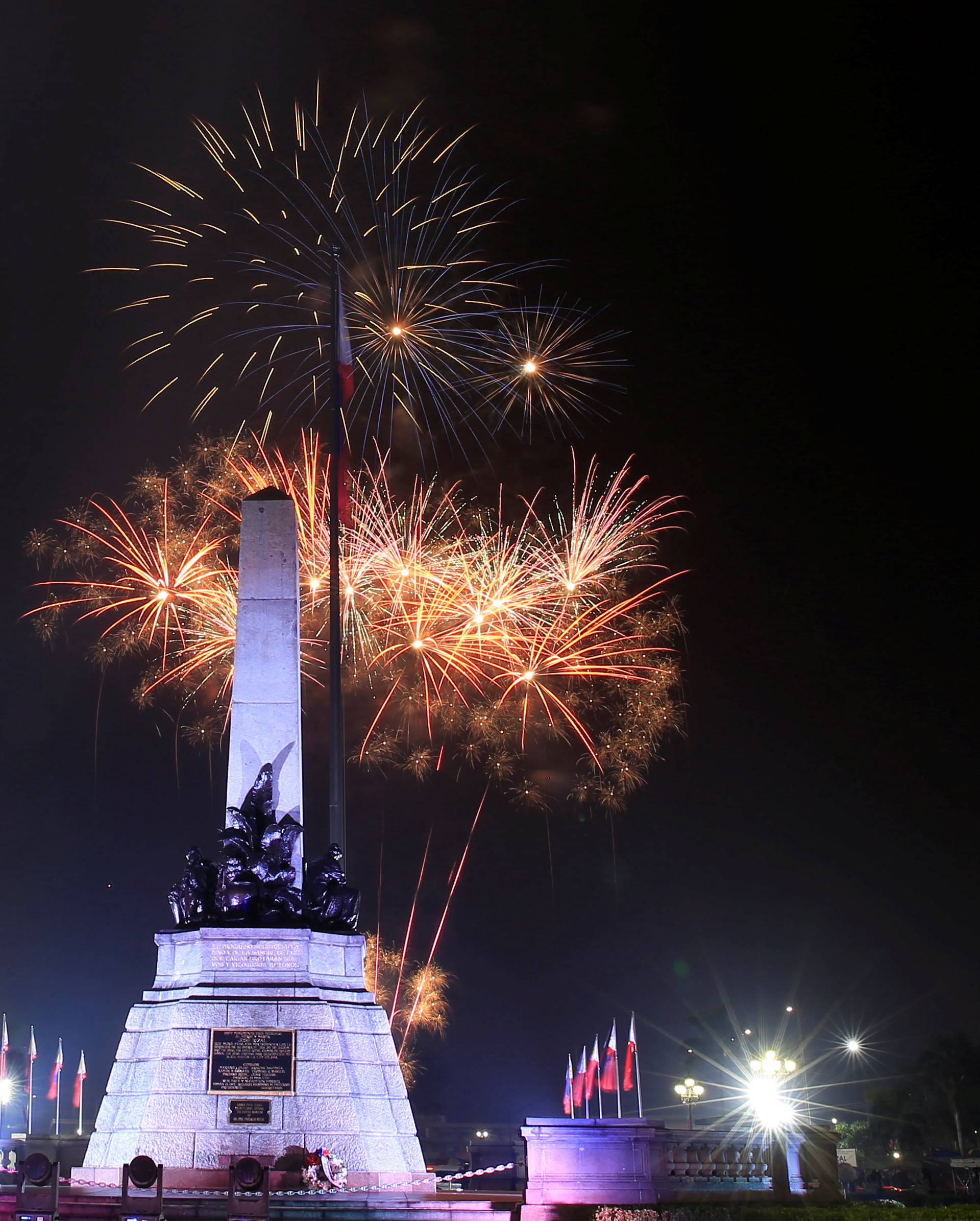 Fireworks explode over the monument of national hero Jose Rizal during New Year celebrations in Luneta park, metro Manila, Philippines