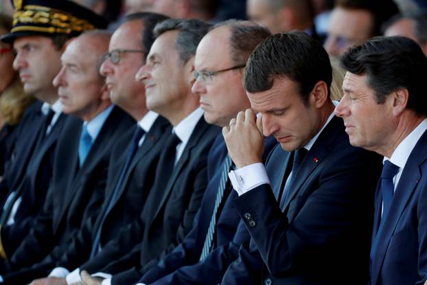 French President Emmanuel Macron reacts during the commemorative ceremony for last year