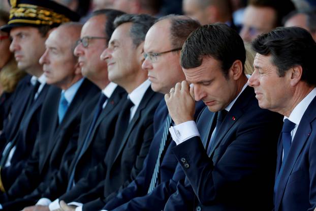 French President Emmanuel Macron reacts during the commemorative ceremony for last year