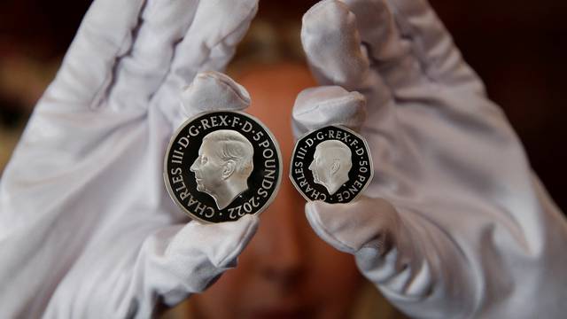 The official coin effigy of Britain’s King Charles III is seen on a £5 crown and 50 pence coin, unveiled by The Royal Mint, in London