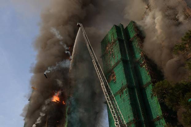 Flames engulf bamboo scaffolding across multiple buildings at Wang Fuk Court housing estate, in Tai Po