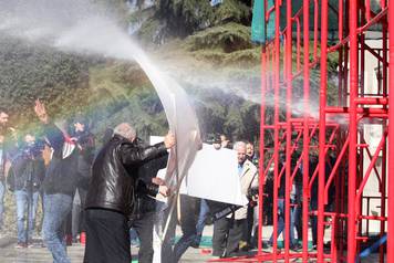 Supporters of the opposition party protest in front of a government building that houses the office of Prime Minister Edi Rama in Tirana