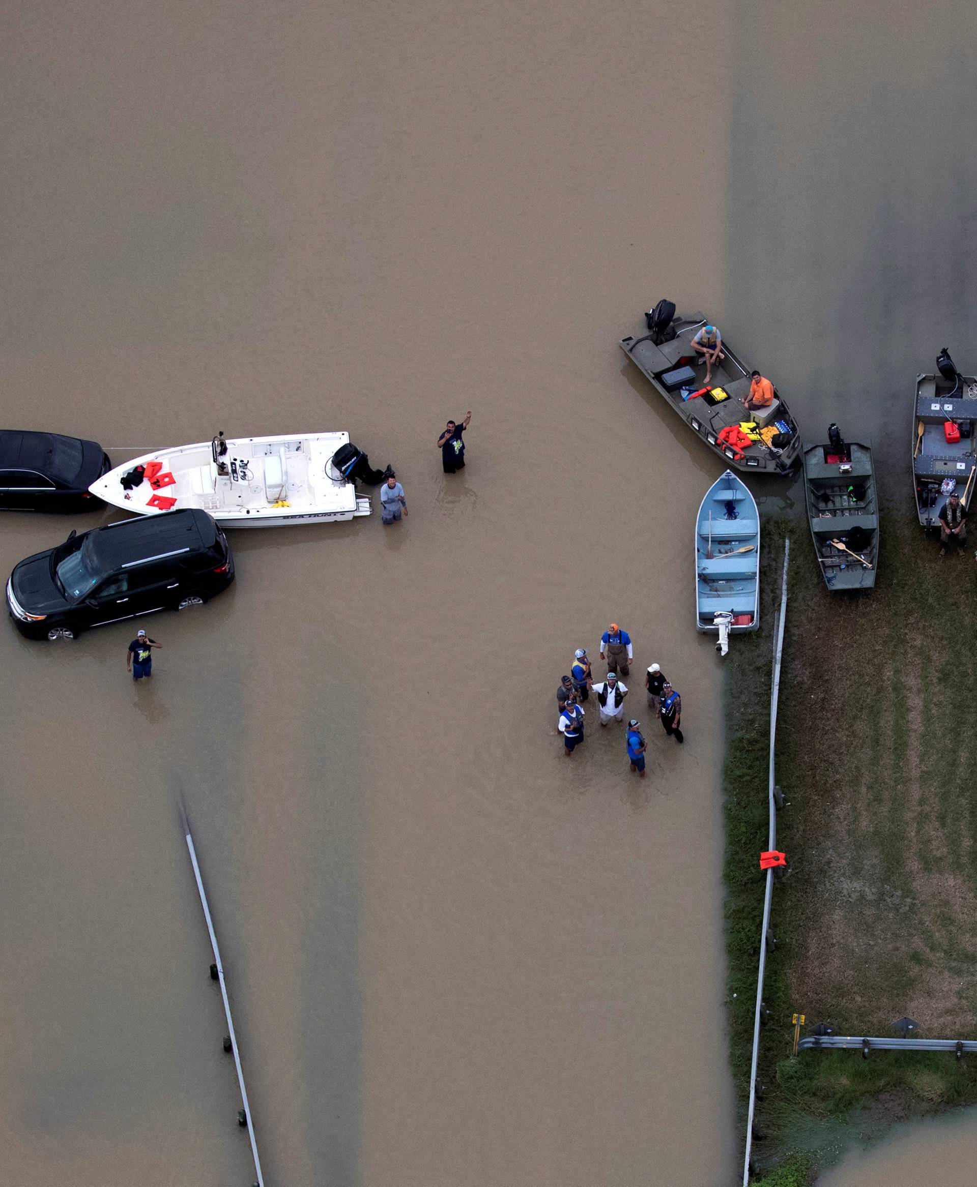 Rescue crews are seen with boats near flood waters brought by Tropical Storm Harvey in West Houston