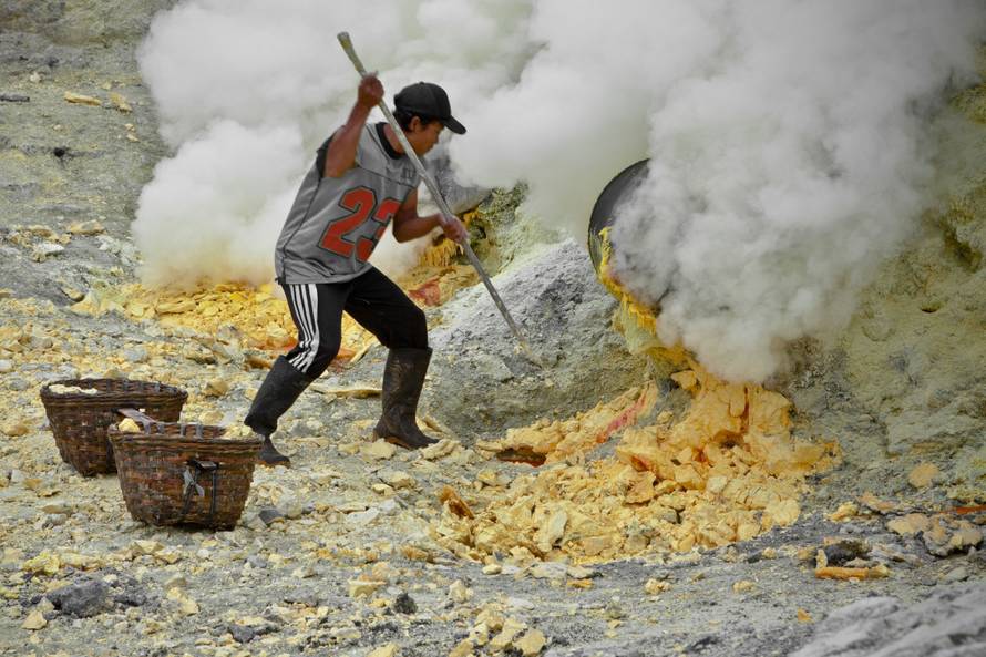 Sulfur workers at Kawa Ijen volcano in the sulfur mine, Kawa Ijen Plateau East Java Indonesia, Pacif
