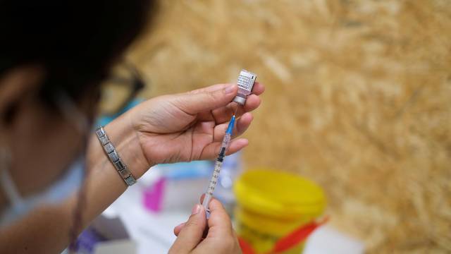 FILE PHOTO: Healthcare worker prepares COVID-19 vaccine at a vaccination centre in Seixal