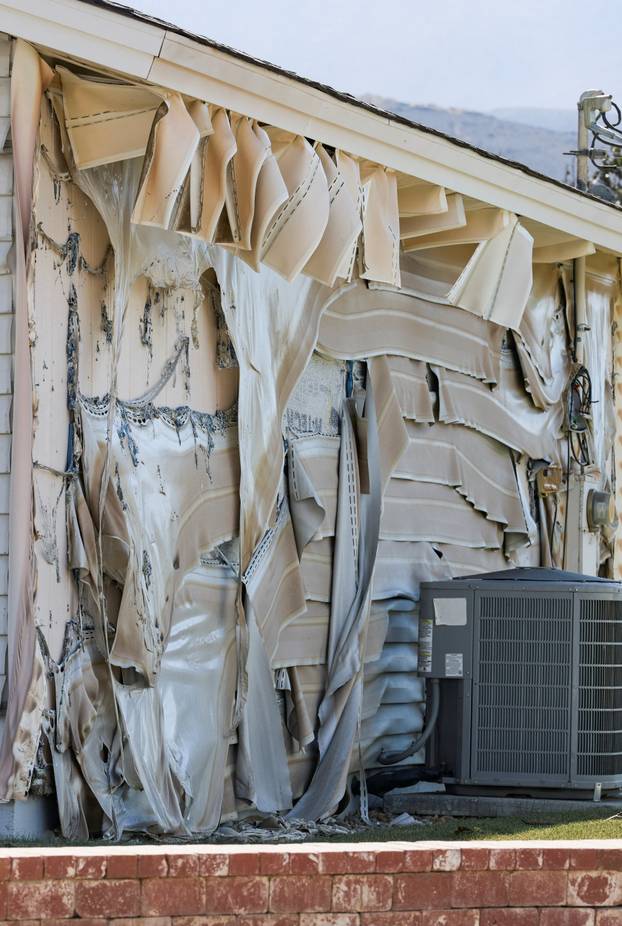 Melted siding on a home near Hawk Fire in Reno
