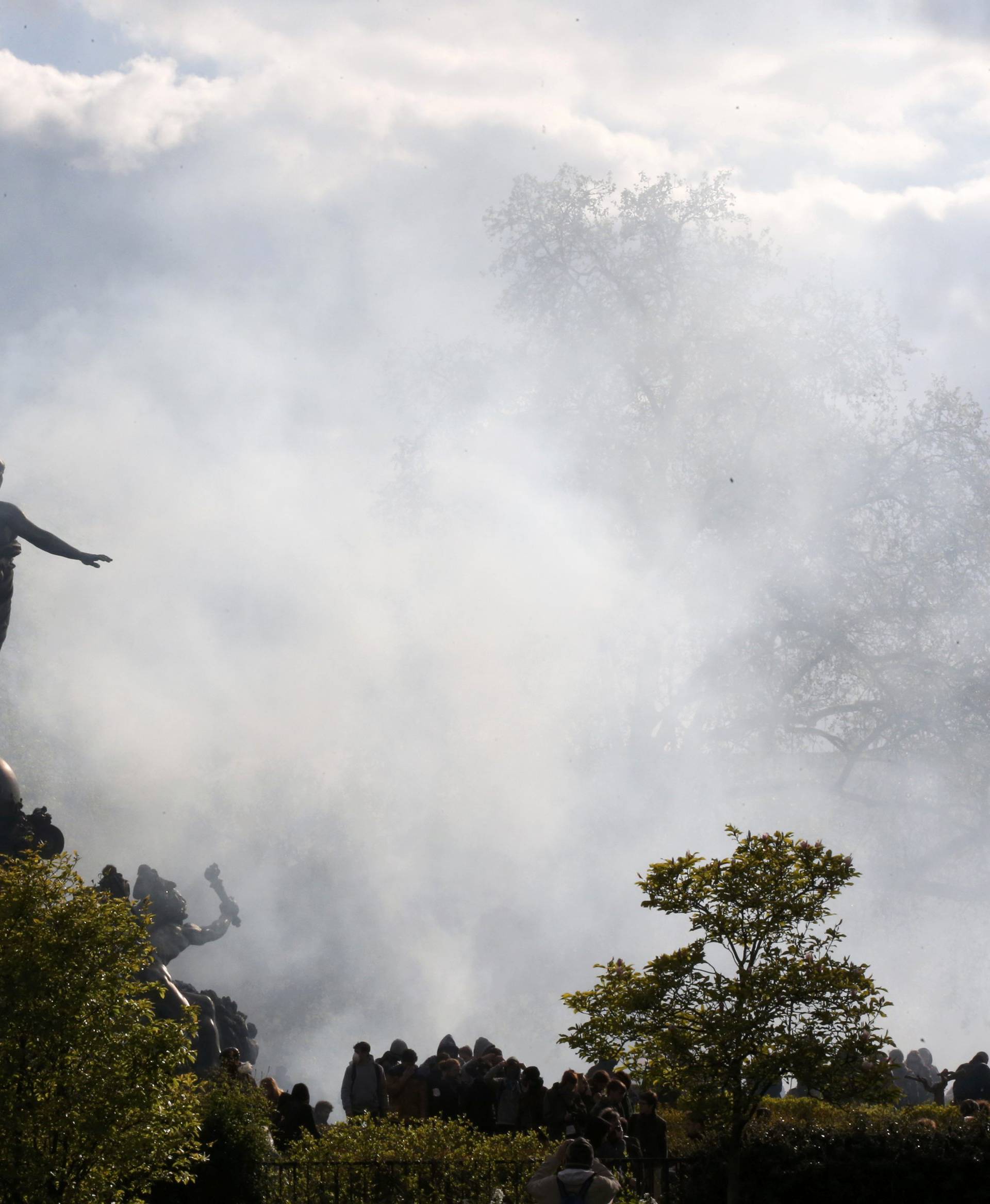 A cloud of tear gas is seen around the statue of the Place de la Nation during clashes between youth and police during a demonstration against the French labour law proposal in Paris