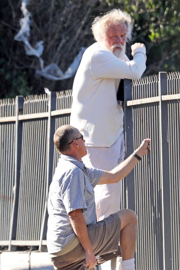 *EXCLUSIVE* Nick Nolte climbs a fence in his PJ