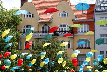 Coloured umbrellas are hanging on ropes over a square to advertise an upcoming wine festival at Berlin's Charlottenburg district in Berlin