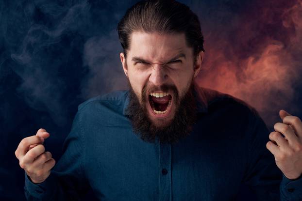 Emotional bearded man angry look shirt smoke in the background