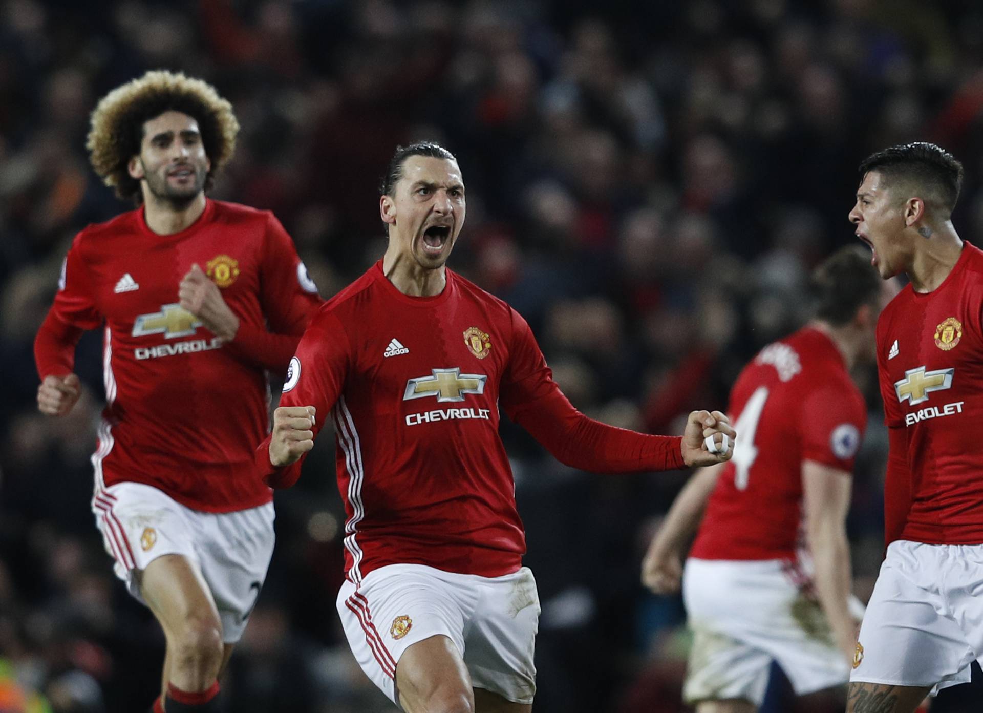Manchester United's Zlatan Ibrahimovic celebrates scoring their first goal with Marcos Rojo and Marouane Fellaini