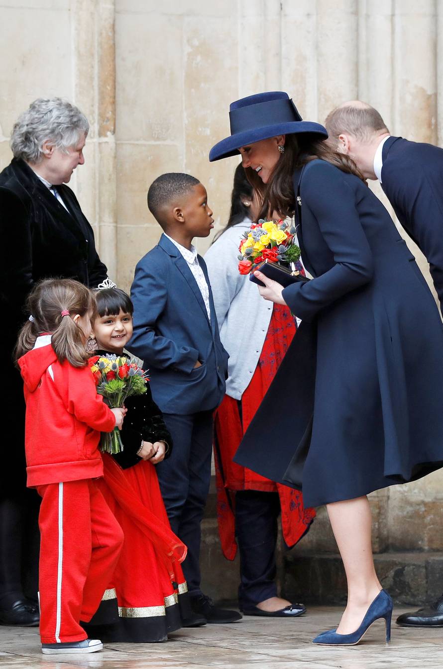 Britain's Prince William and Catherine, the Duchess of Cambridge, greet children after attending the Commonwealth Service at Westminster Abbey in London