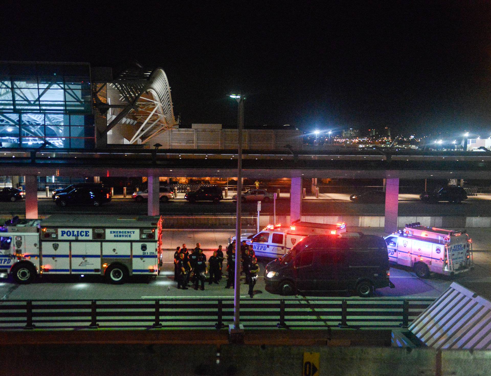 Members of the New York City Police Department stand guard at Terminal 8 at John F. Kennedy airport in the Queens borough of New York City