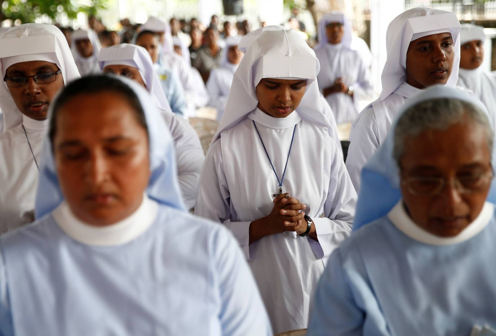 Nuns attend a mass near St Sebastian Church during a memorial service in Negombo