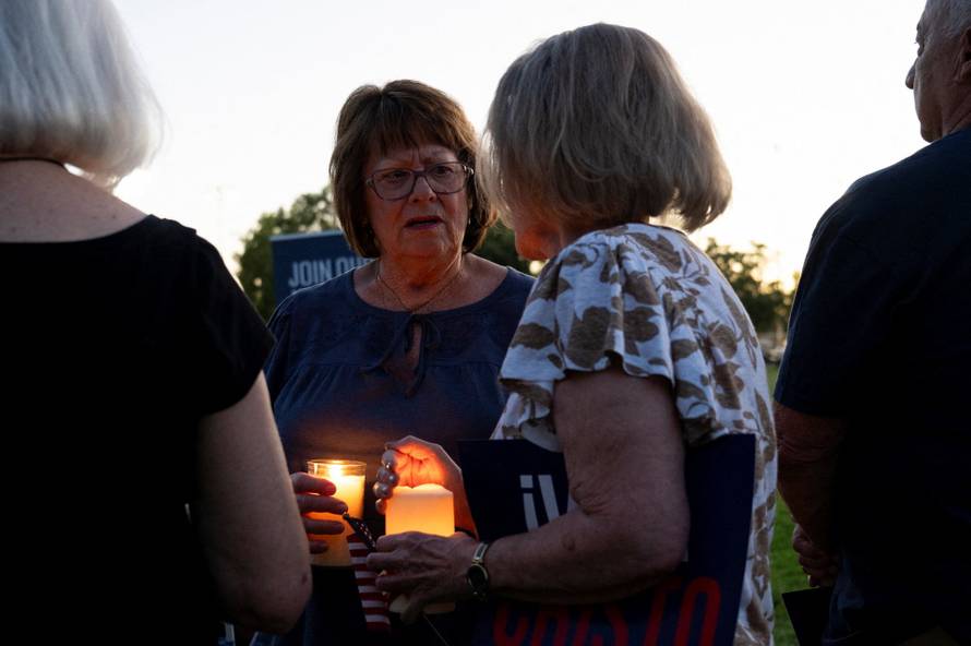 Catholics from across the Phoenix area gather to pray for Charlie Kirk, who was shot and killed in Utah, at Desert Horizon Park in Scottsdale